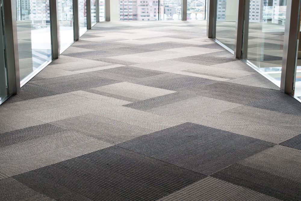 A well-lit hallway adorned with a large carpet area, representing carpet tile flooring service in San Francisco, CA.